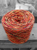Black, red, yellow, and orange cotton variegated yarn.